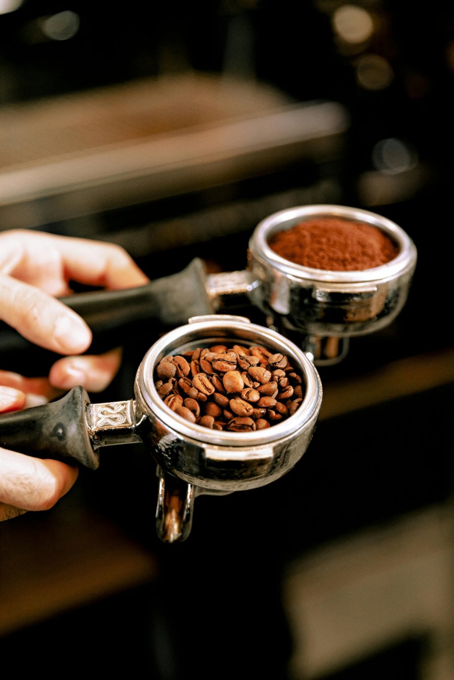 Siebträger mit frisch gemahlenem Kaffee und Espressobohnen